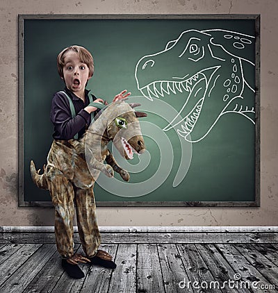 Surprised boy dressed in fancy dress as a dinosaur Stock Photo