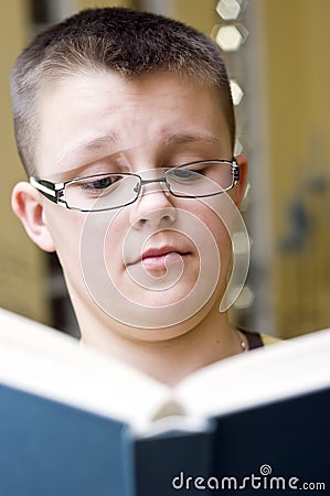 Surprised boy reading a book Stock Photo