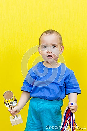 Surprised boy with sports awards Stock Photo