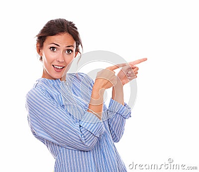 Surprised brunette pointing to her left Stock Photo