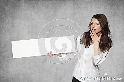 Surprised businesswoman holds a place for your advertisement Stock Photo