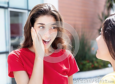 Surprised caucasian girl speaking with girlfriend Stock Photo
