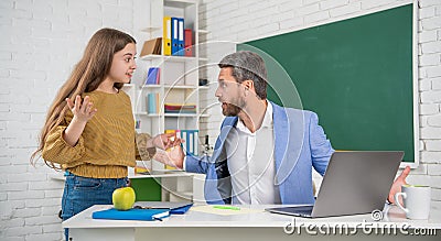 surprised child with man tutor in classroom. education Stock Photo
