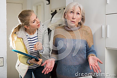 Surprised elderly woman cannot answer questions of interviewer at home Stock Photo