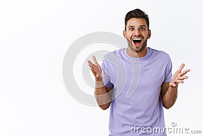 Surprised, excited and fascinated handsome bearded man express astonishment as heard about interest project, discuss Stock Photo