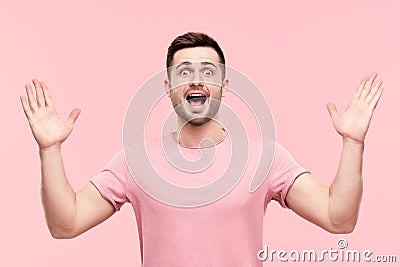 Surprised excited man portrait with arms raised Stock Photo