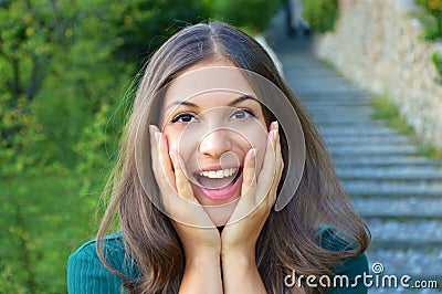 Surprised excited young woman holding her face showing smile Stock Photo