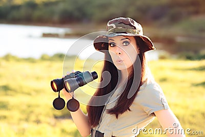 Surprised Explorer Girl with Camouflage Hat and Binoculars Stock Photo