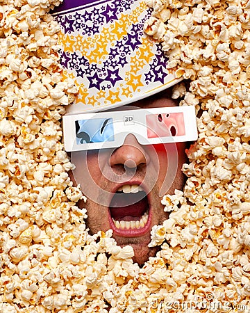 Surprised face in popcorn watching 3D movie Stock Photo