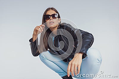 Surprised fashion model gasping while wearing sunglasses Stock Photo