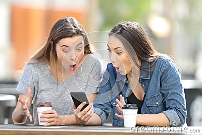 Surprised friends finding amazing phone online content Stock Photo