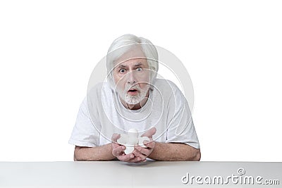 Surprised Or Frightened Old Man Caught Holding His Chicken Eggs Stock Photo