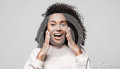 Surprised happy girl portrait. Emotional african american woman with hands near face talking Stock Photo