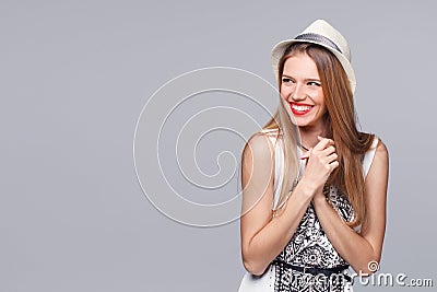 Surprised happy young woman looking sideways in excitement. Isolated over gray Stock Photo