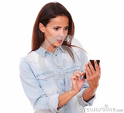 Surprised hispanic female reading a text Stock Photo