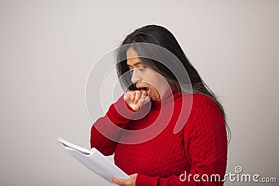 Surprised Hispanic Woman Looks At Notes Stock Photo