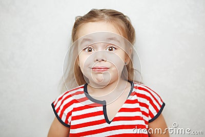 Surprised little girl with arched eyebrows portrait photo Stock Photo