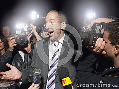 Surprised Man Surrounded By Paparazzi Stock Photo