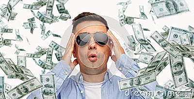 Surprised man under dollar money rain Stock Photo