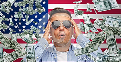 Surprised man under money rain over american flag Stock Photo