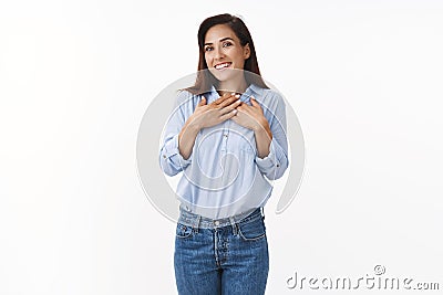 Surprised middle-aged wife pleased, hold hands chest thankful, tilt head smiling amazed, husband give tender lovely gift Stock Photo