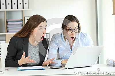 Surprised office workers reading online news Stock Photo