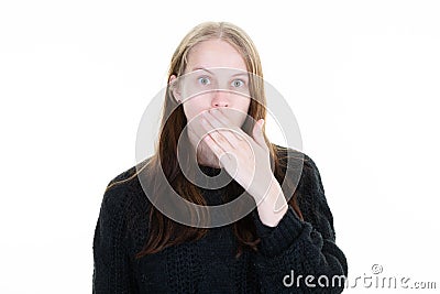 Surprised outraged woman with hand over mouth posing in white background studio Stock Photo