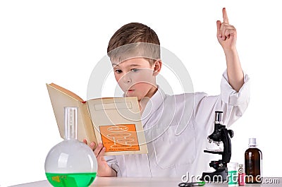 Surprised scientist boy find solution in his book Stock Photo