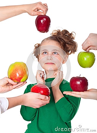 Surprised smiling girl choosing proposed apples Stock Photo