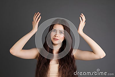 Surprised terrified female gestures with uncertainly, puzzled as doesn`t know answer on trick question Stock Photo