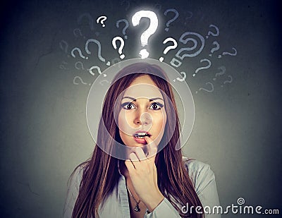 Surprised woman with many questions and no explanation or answer Stock Photo