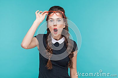 Surprised woman in red glasses amazement looking at camera Stock Photo