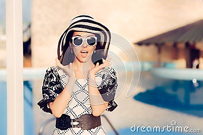 Surprised Woman With Sunglasses and Sun Hat by the Pool Stock Photo