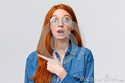 Surprised and wondered, amused attractive redhead woman in glasses, red natural hair, freckles, blue eyes open mouth Stock Photo