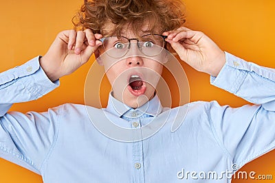 Surprised wonk boy in eyeglasses look at camera in shock Stock Photo