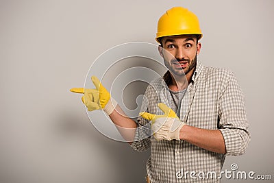 Workman in helmet and safety gloves Stock Photo