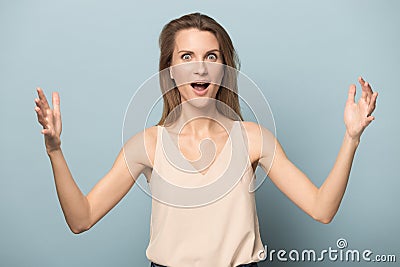 Amazed young woman show large scale measurement with hands Stock Photo