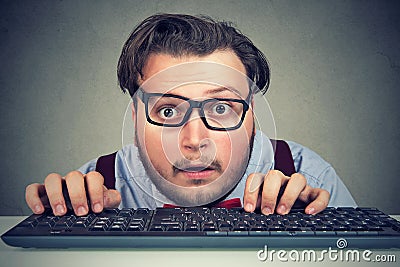 Surprised business man typing on key board Stock Photo