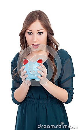 Surprised young girl with a blue money-box Stock Photo