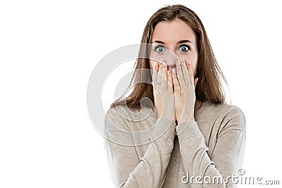 Surprised young girl covers her mouth with her hands Stock Photo