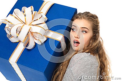 Surprised young woman with big gift box on white background Stock Photo