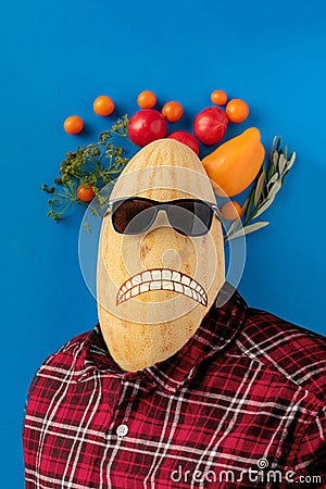 surreal art concept of a human body with a fruit head and face, isolated against the colorful wall Stock Photo