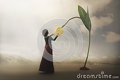 Surreal encounter of a girl who gently touches a giant flower Stock Photo