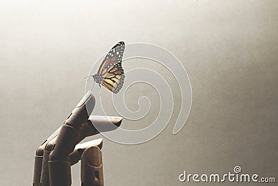 Surreal encounter between a wooden hand and a colorful butterfly Stock Photo