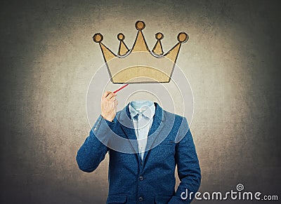 Surreal image as a businessman with invisible face holding a pencil in his hand draw crown symbol instead of head. Business Stock Photo