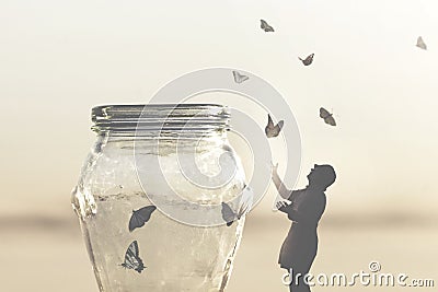 Surreal image of a woman who gives freedom to butterflies captive in a vase Stock Photo