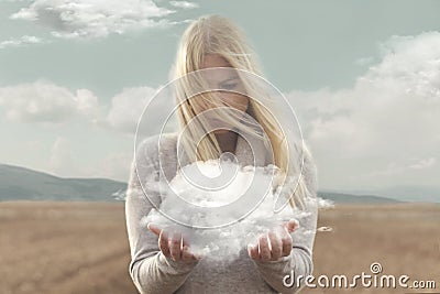 Surreal moment , woman holding in her hands a soft cloud Stock Photo