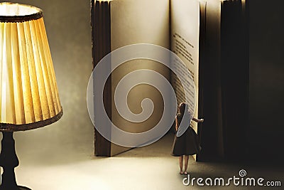 Surreal moment of a woman opening the blank pages of a giant book, knowledge concept Stock Photo