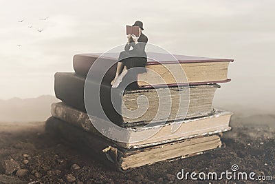 Surreal image of a woman reading sitting on top of a book Stock Photo