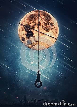 Surreal nightscape with a boy sways on a swing hanging from the full moon. Beautiful starry night with falling comets. Fantasy and Stock Photo